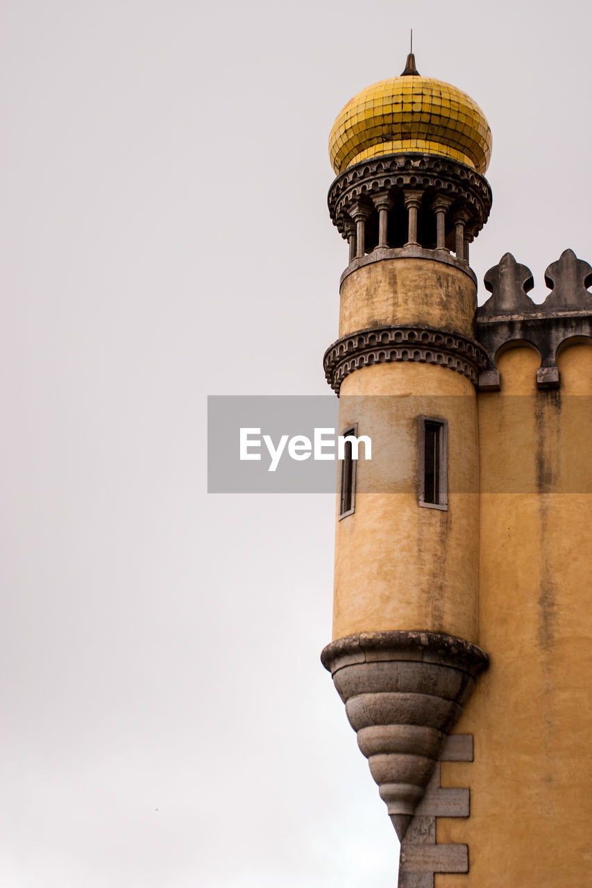 Low angle view of pena national palace against clear sky