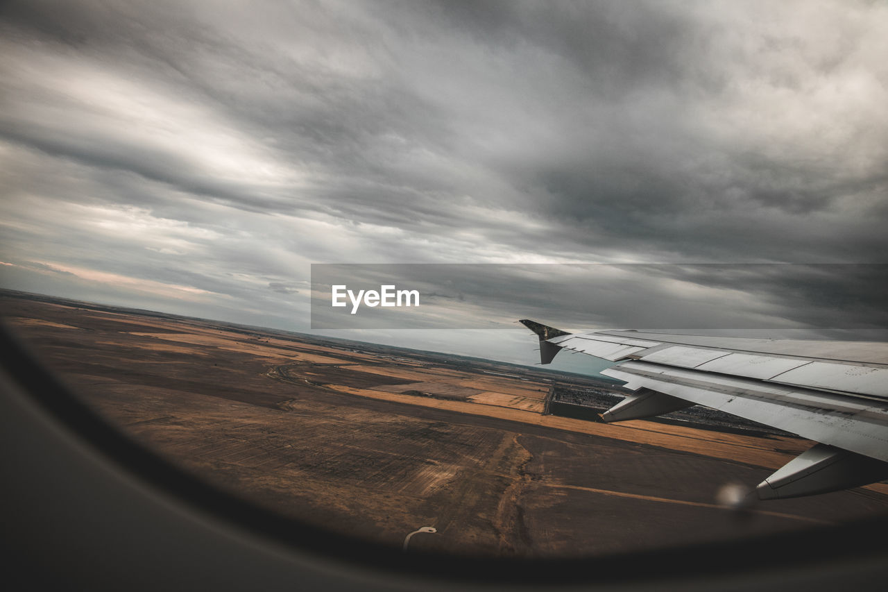 AIRPLANE ON CLOUDY SKY