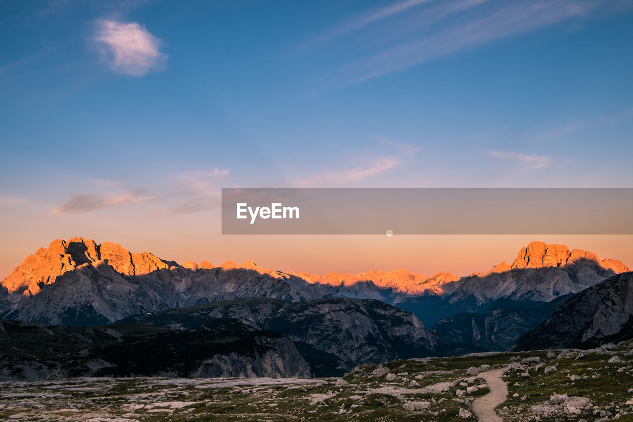 Scenic view of snowcapped mountains against sky during sunset