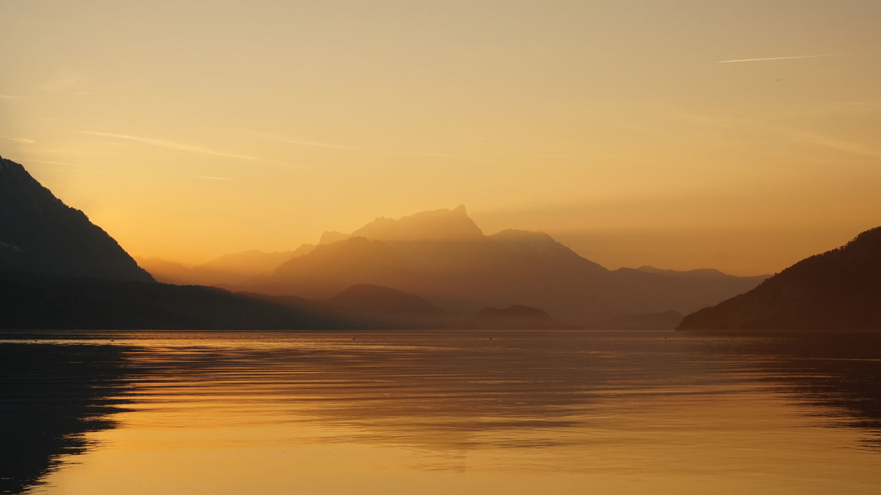 Scenic view of lake against sky during sunset