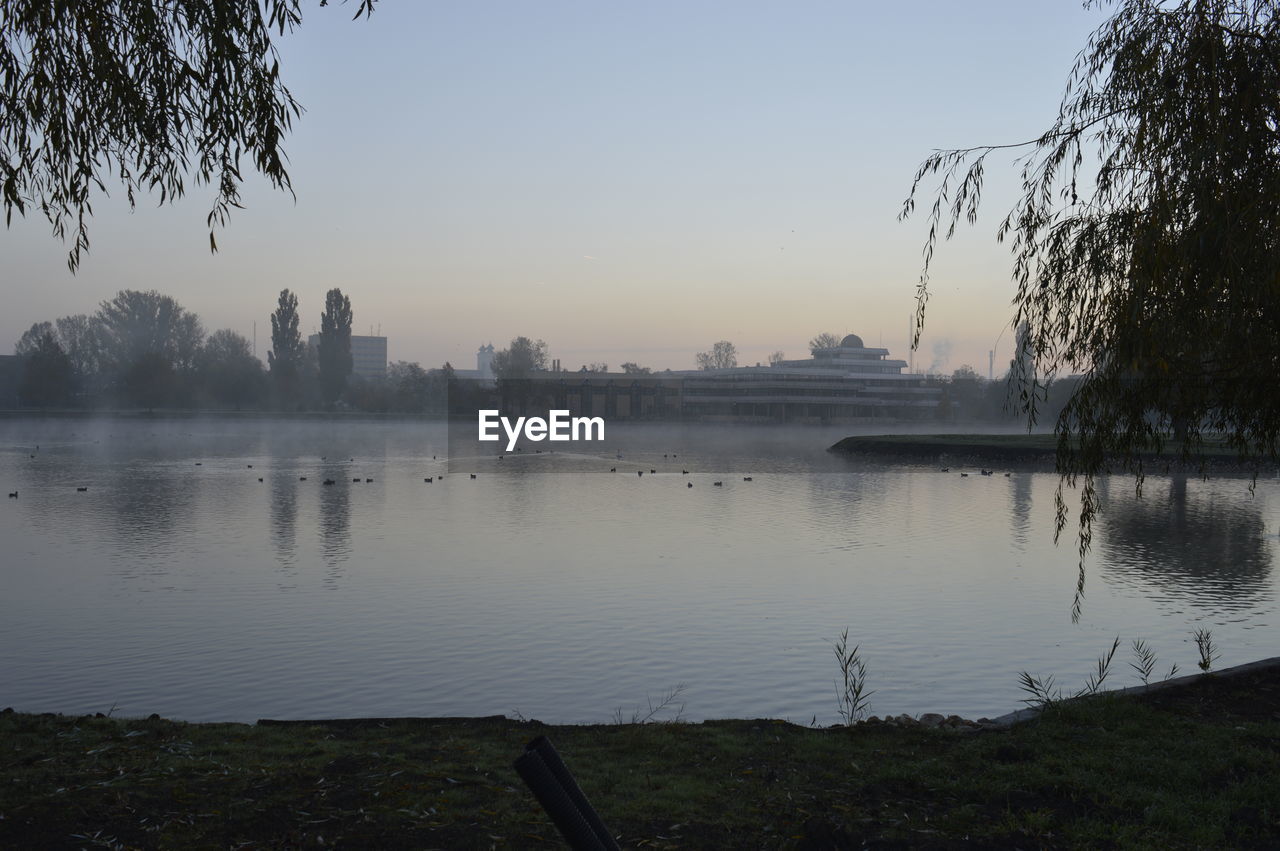 Scenic view of lake against sky during sunset