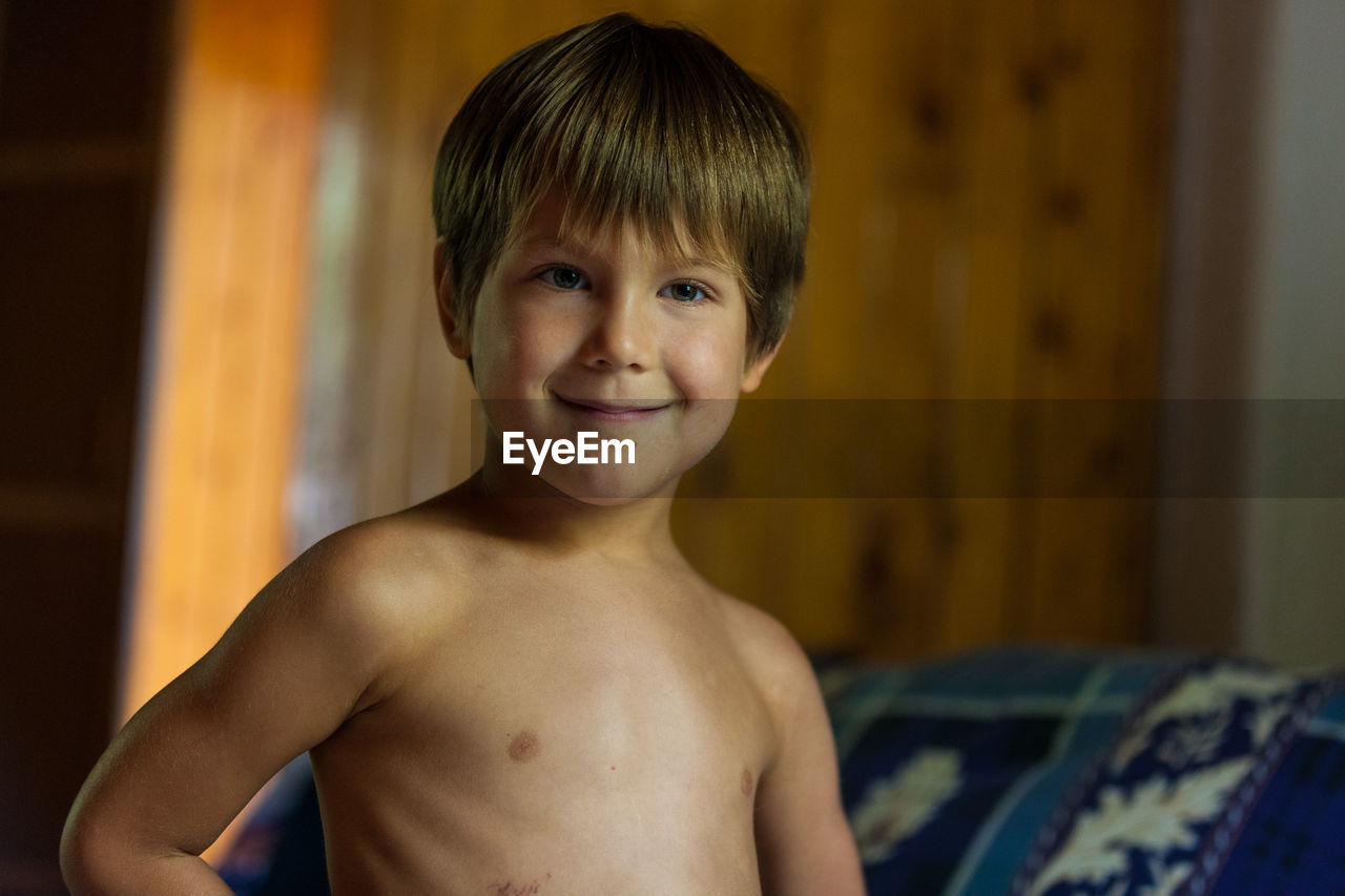 Portrait of shirtless boy at home