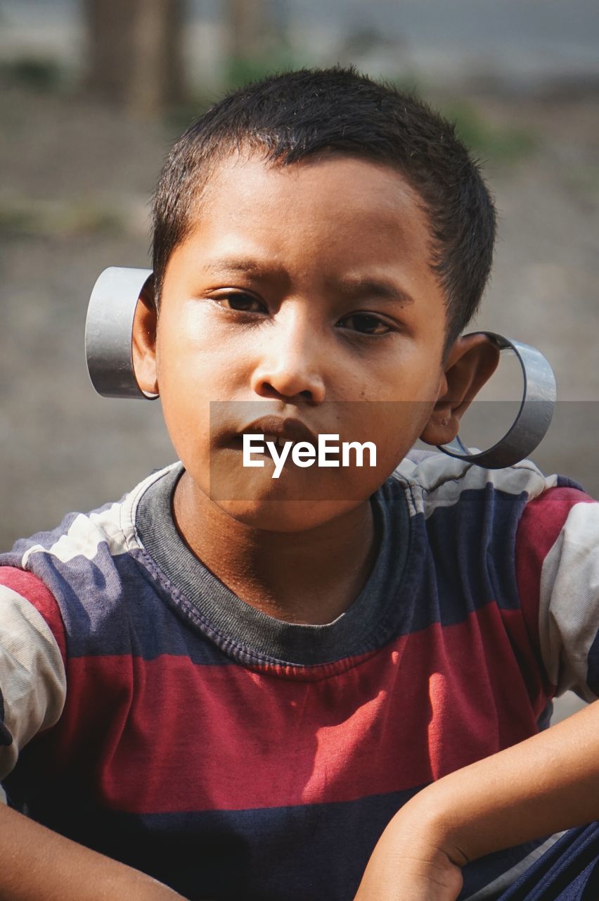 Portrait of boy with metal on ears