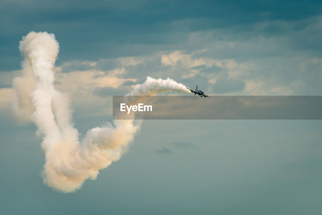 Low angle view of airshow against sky