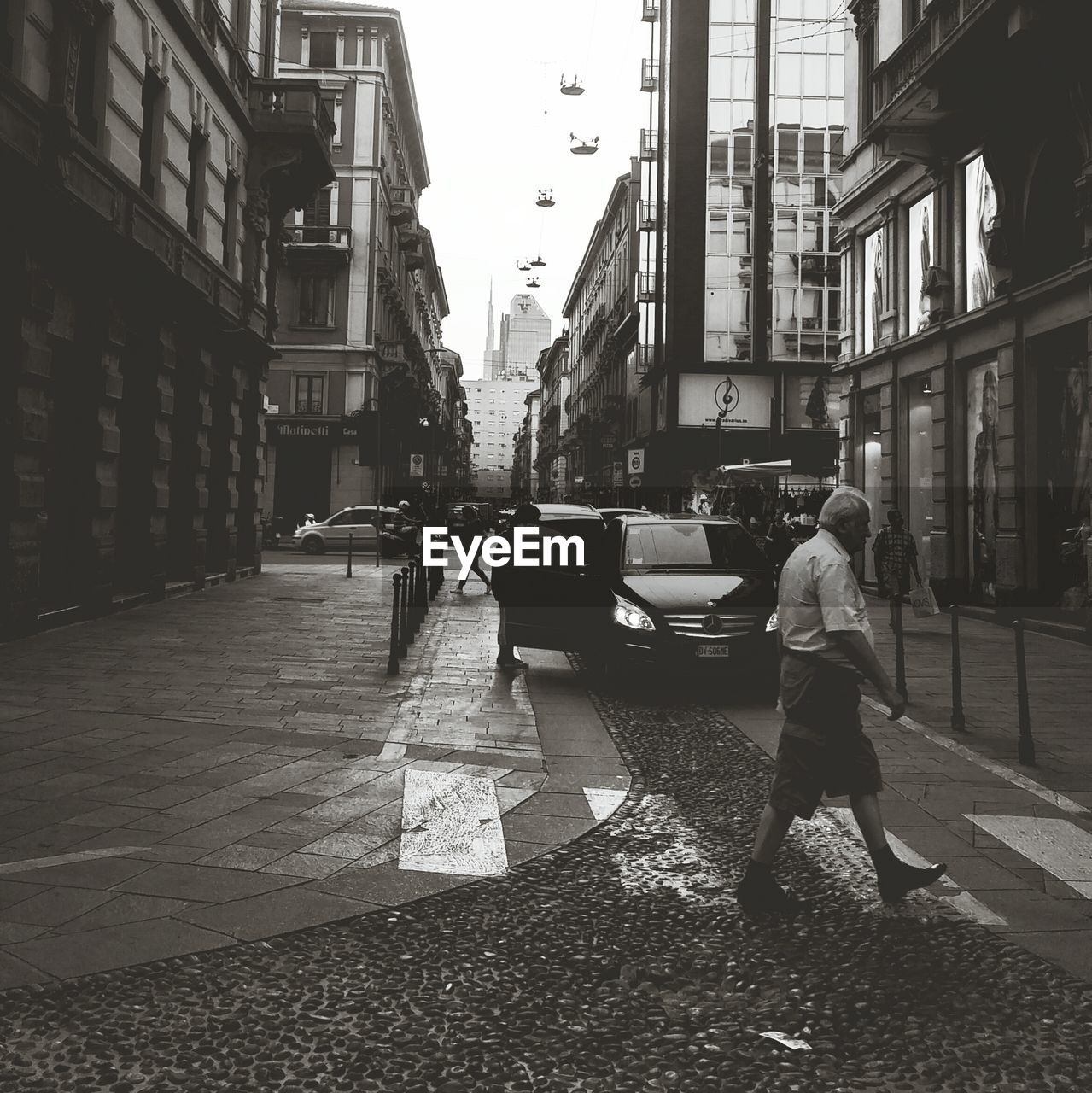 WOMAN STANDING ON CITY STREET