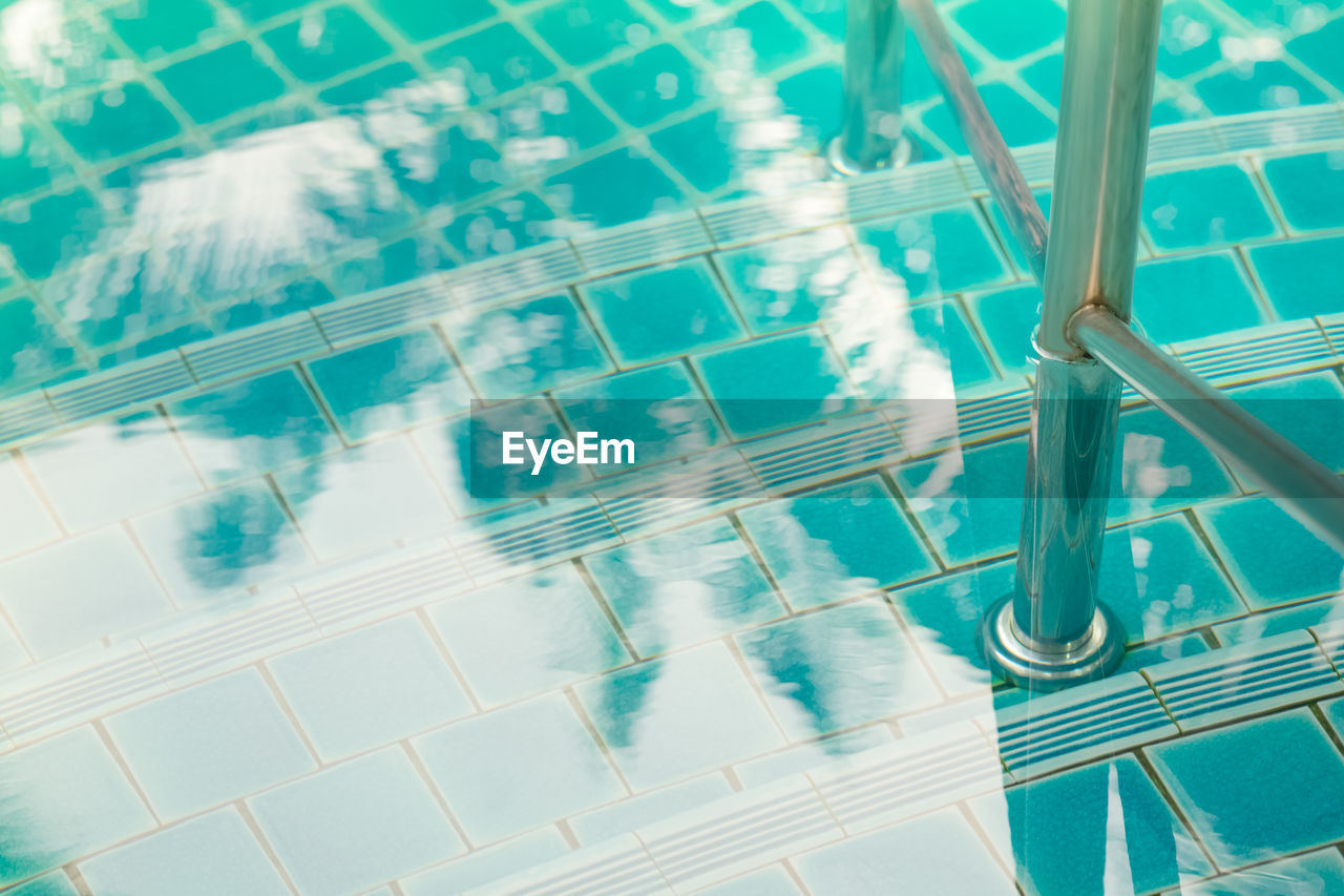 HIGH ANGLE VIEW OF SWIMMING POOL WITH REFLECTION OF WATER