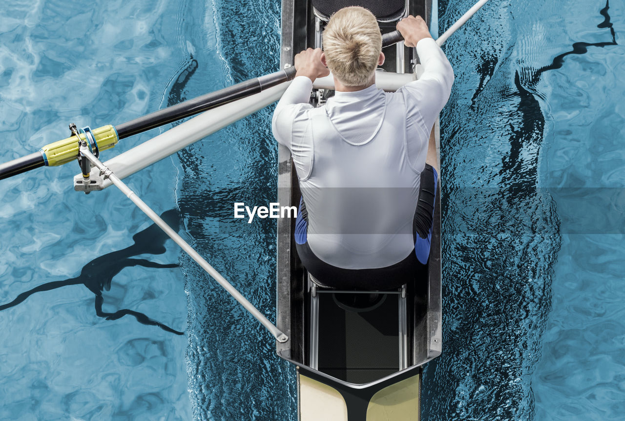 Directly above shot of young man rowing rowboat on river