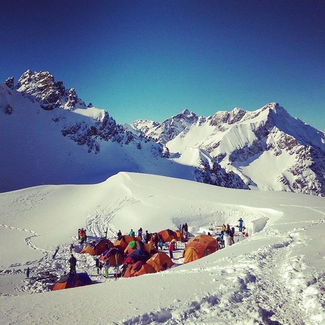 TOURISTS ON SNOW COVERED MOUNTAIN