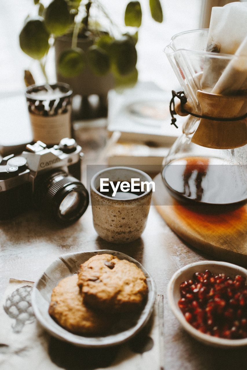 CLOSE-UP OF COFFEE SERVED WITH SPOON AND TABLE