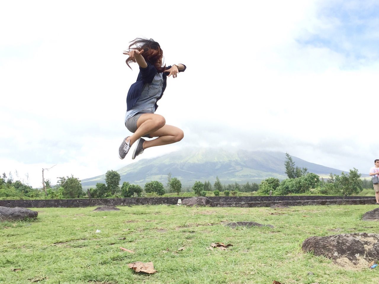 Full length of woman jumping on grass