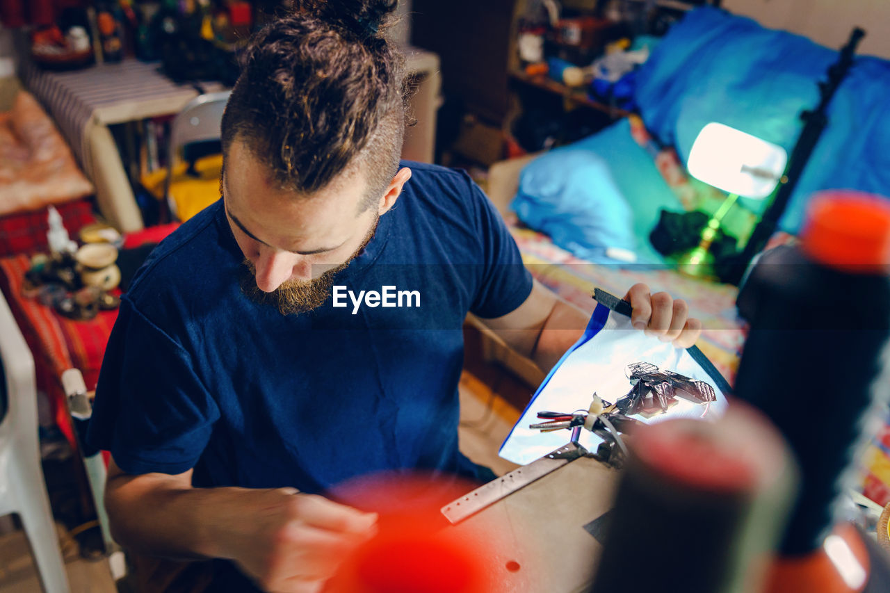 Man working on sewing machine