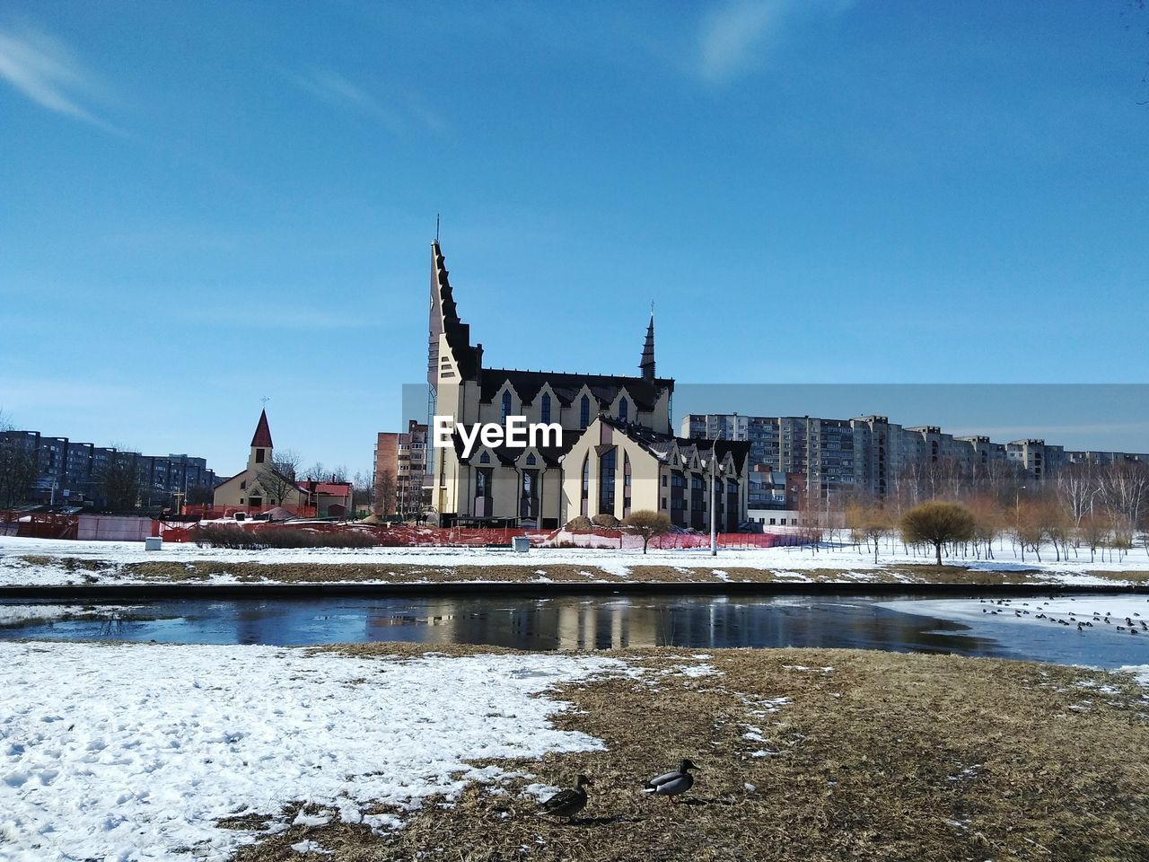 View of city at riverbank during winter