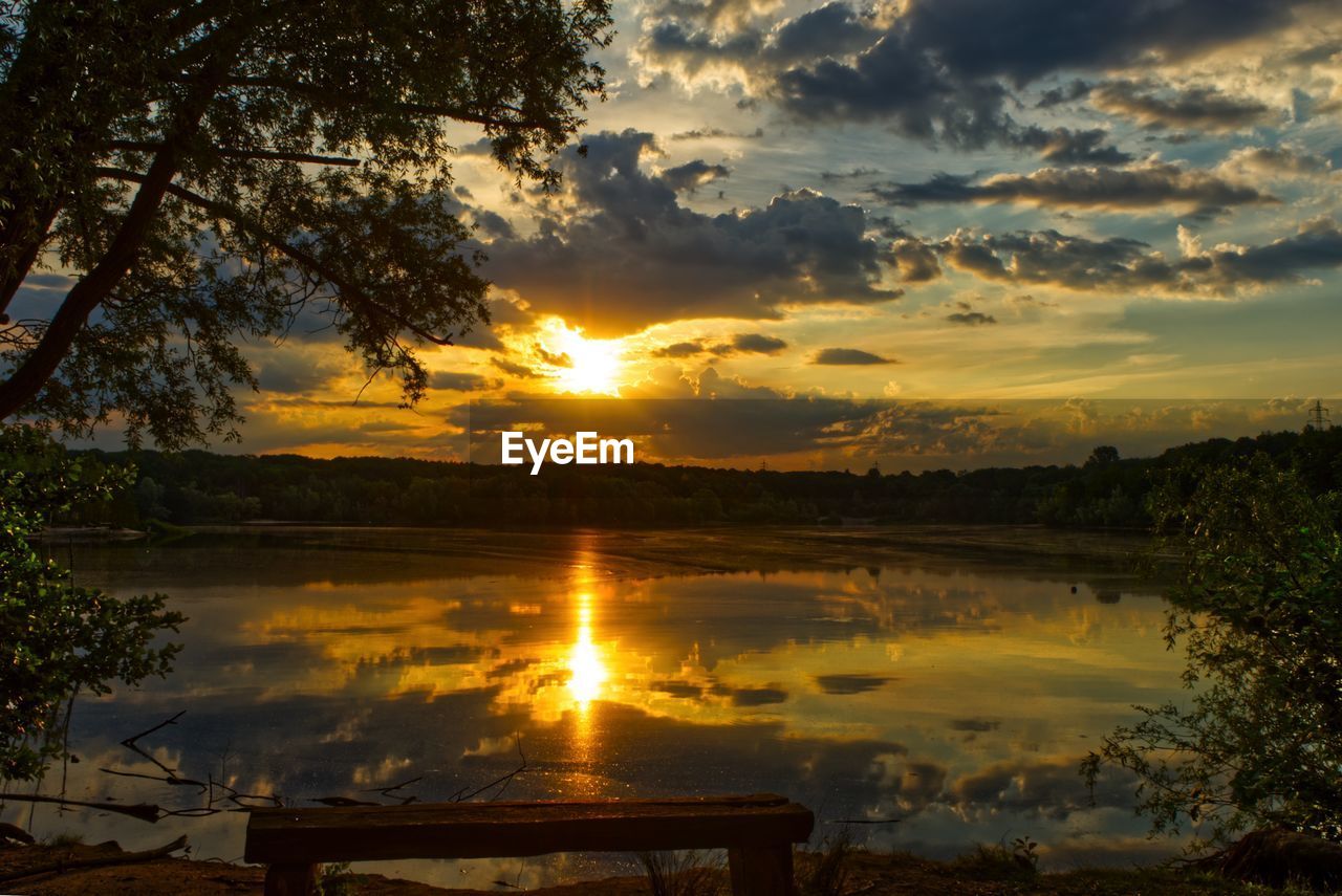 SCENIC VIEW OF LAKE AGAINST ORANGE SKY DURING SUNSET