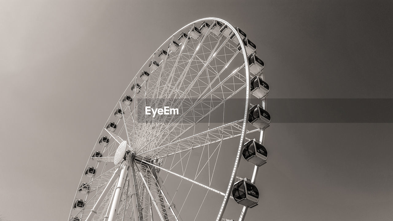 Low angle view of ferris wheel against sky