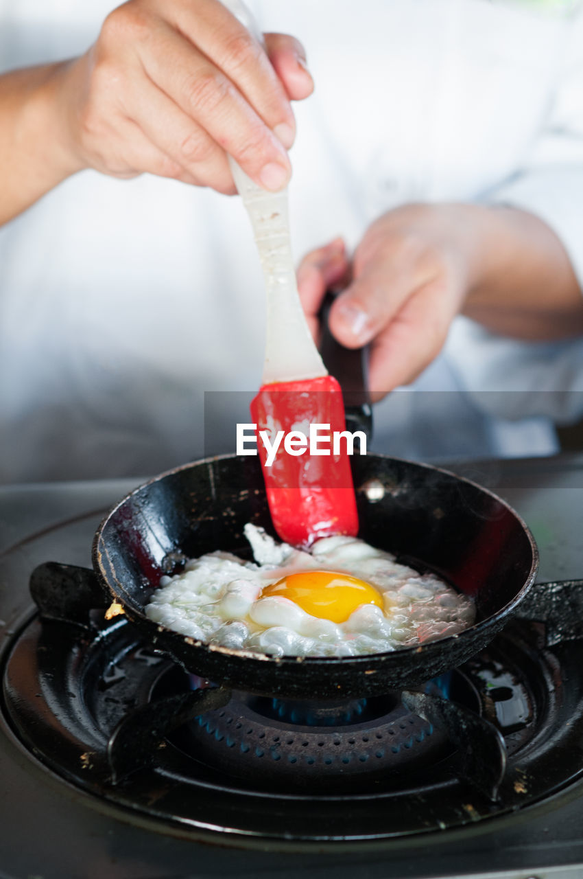 Midsection of person preparing food