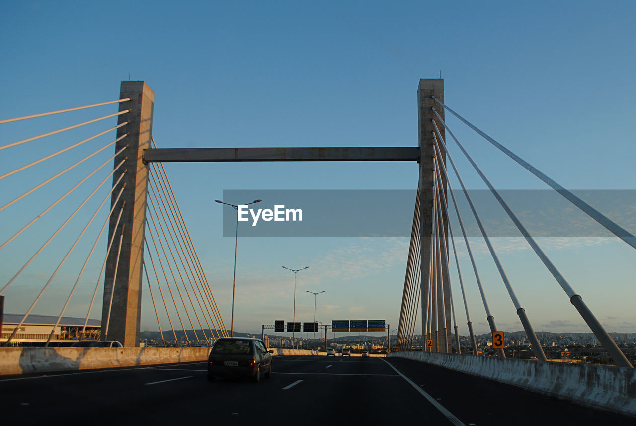 VIEW OF SUSPENSION BRIDGE AGAINST CLEAR SKY