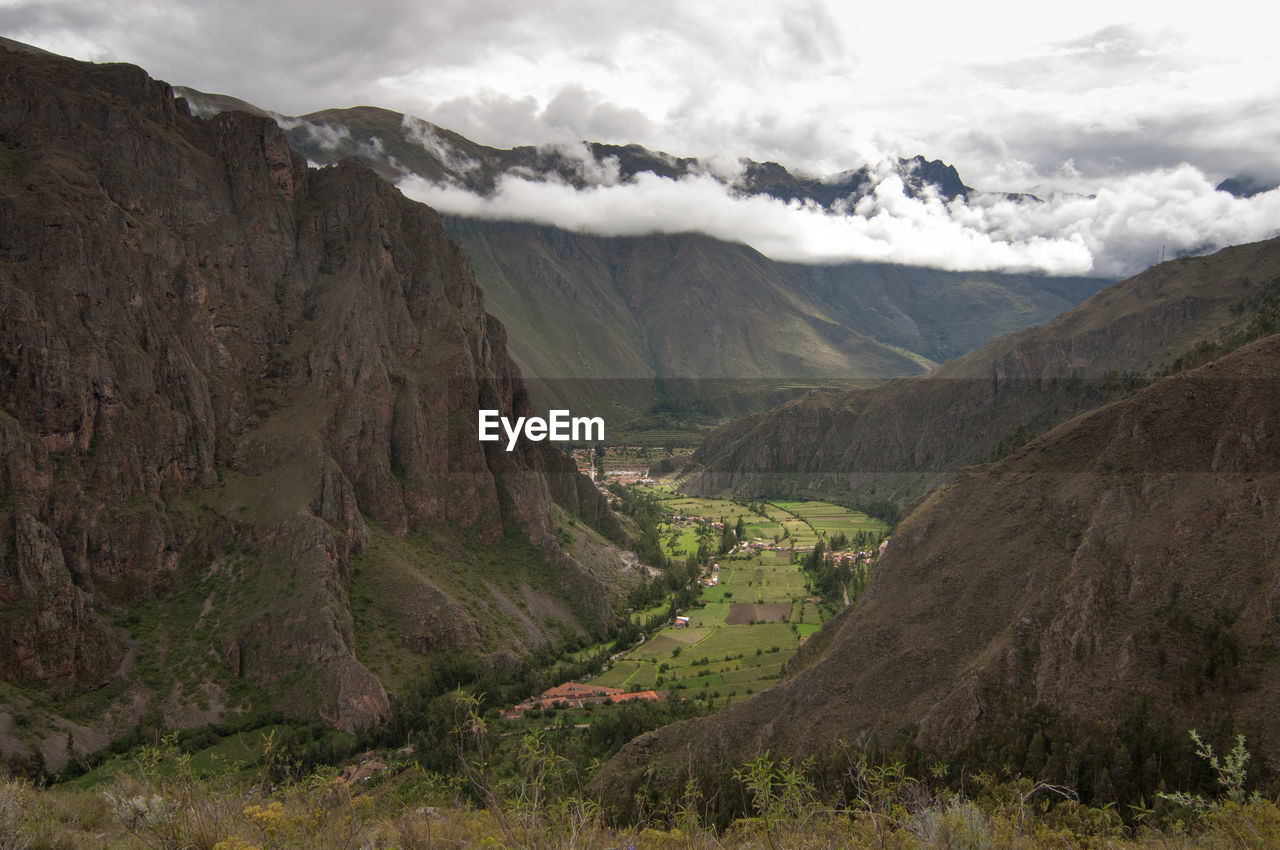 Scenic view of andes mountains against cloudy sky