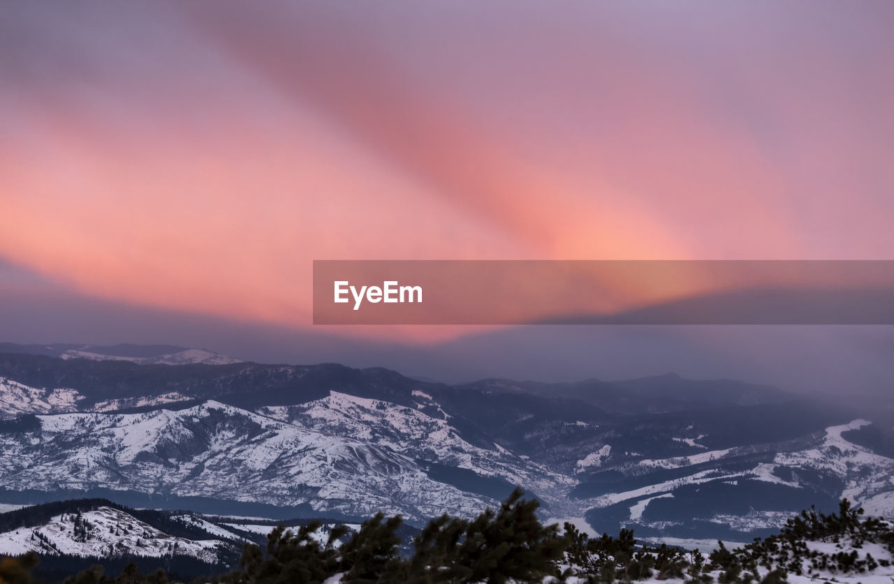 Scenic view of mountains against sky during winter