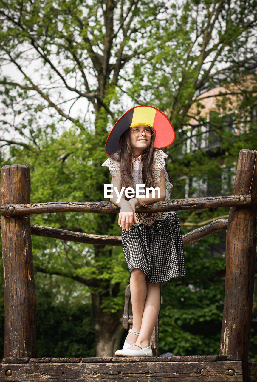 Portrait of a beautiful caucasian girl wearing a belgian flag hat.