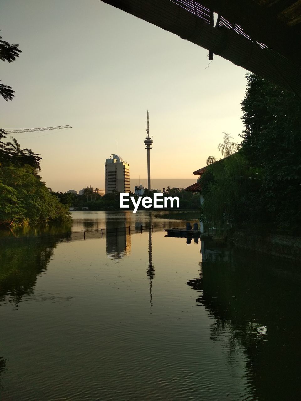 Reflection of buildings in lake at sunset