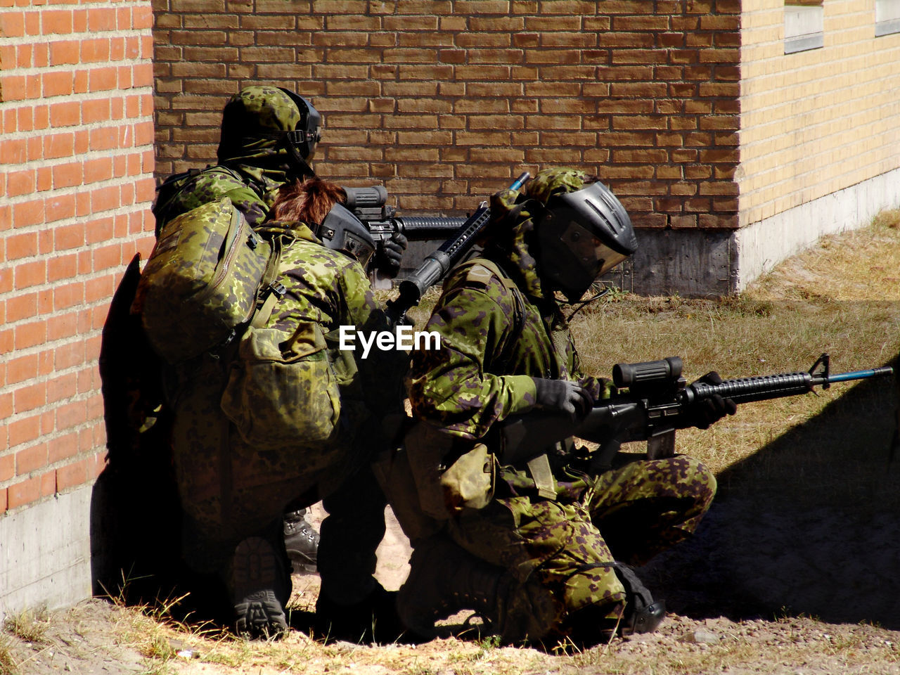 low angle view of army soldiers standing on grassy field