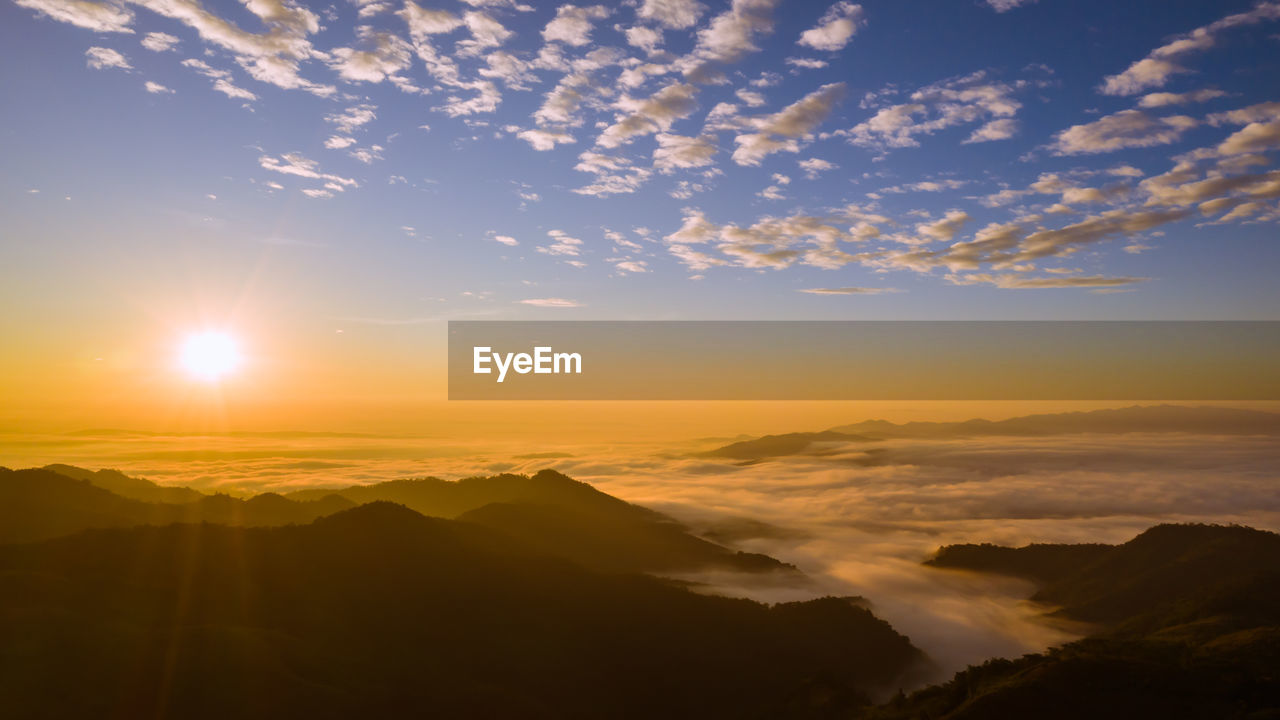 Mountain peak and the sea fog blue sky and the sunrise background at morning time landmark 