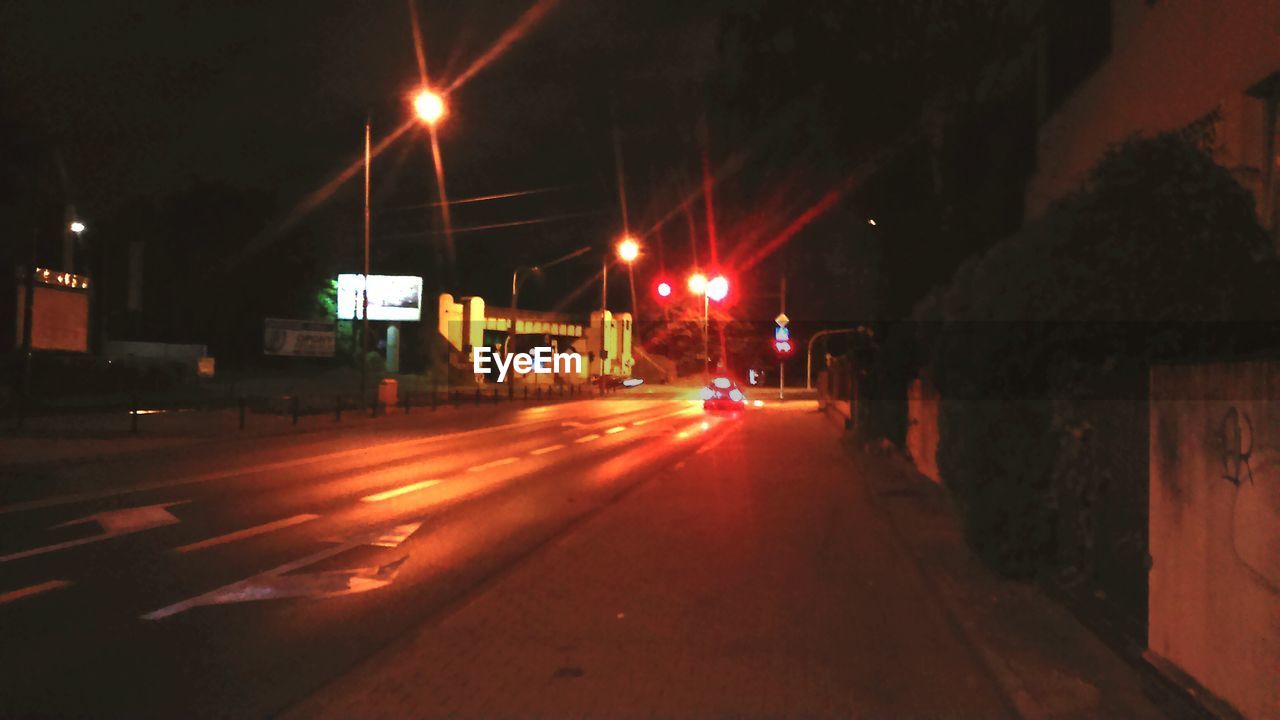 ILLUMINATED CITY STREET AT NIGHT