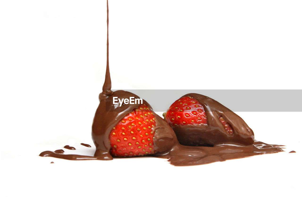 Delicious chocolate over fresh strawberry