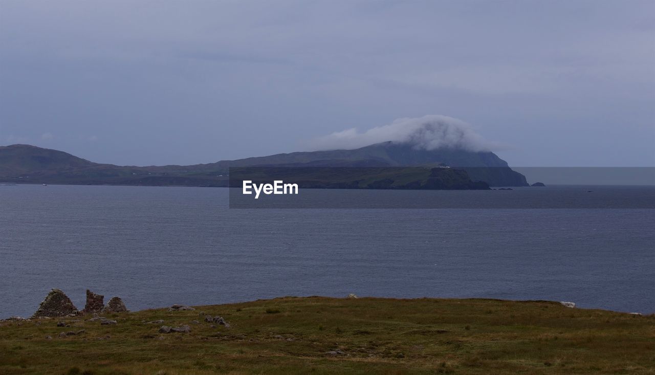 SCENIC VIEW OF LAKE AGAINST MOUNTAIN