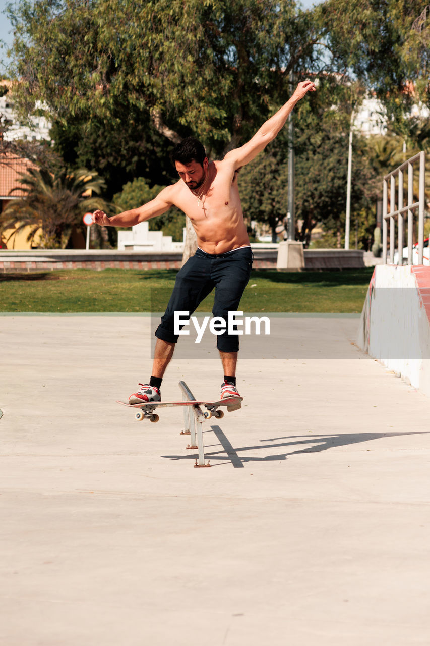 Boy doing skateboard trick on rail