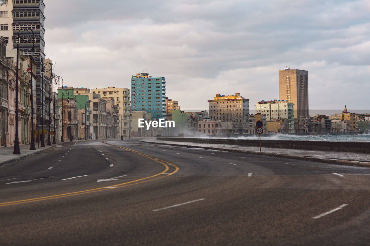 City street by buildings against sky