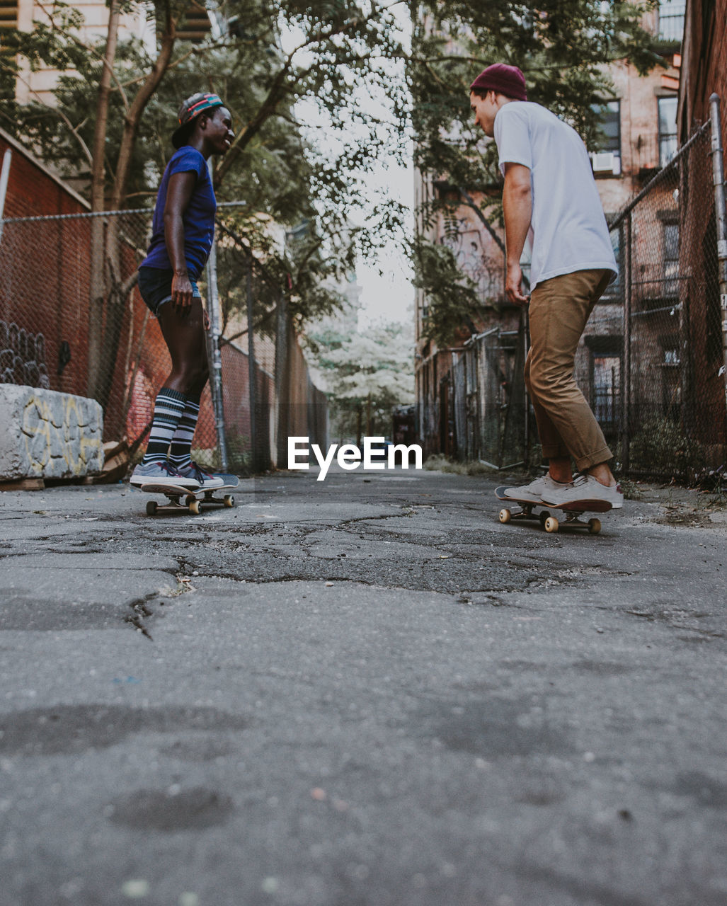 MAN SKATEBOARDING ON SKATEBOARD IN PARK