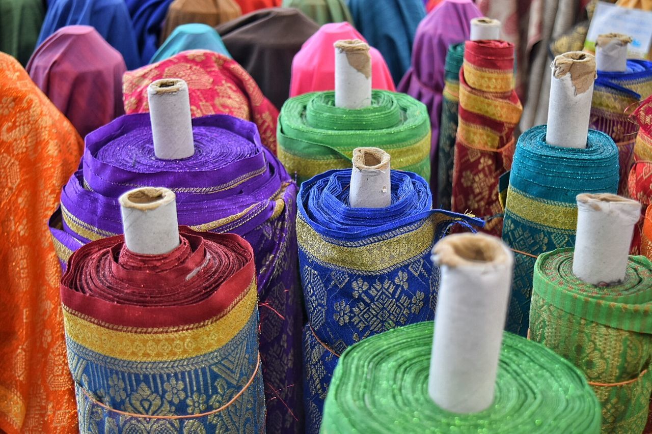 Multi colored spools of fabric for sale