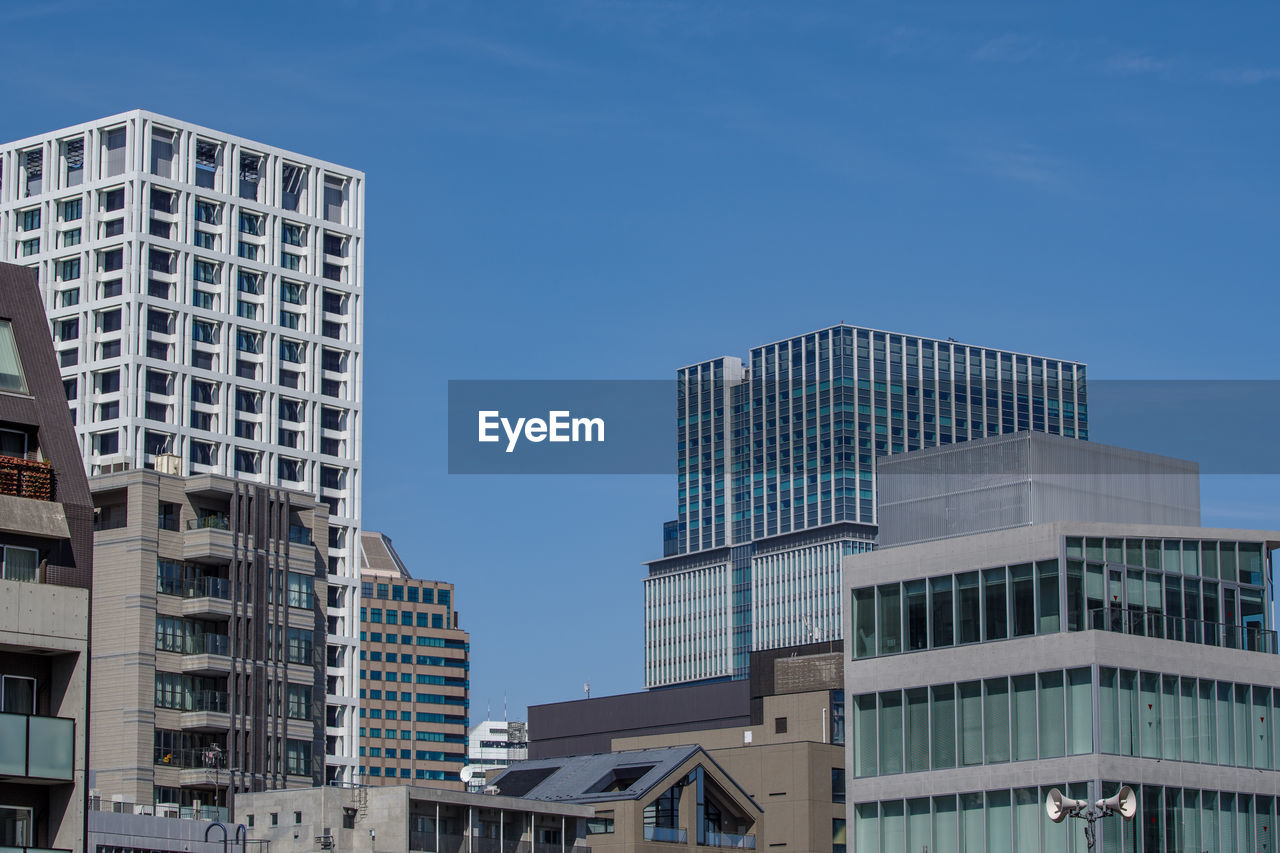 low angle view of skyscrapers against sky