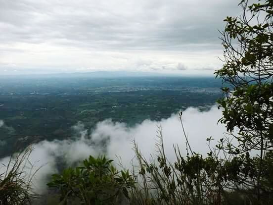 SCENIC VIEW OF MOUNTAINS AGAINST CLOUDY SKY