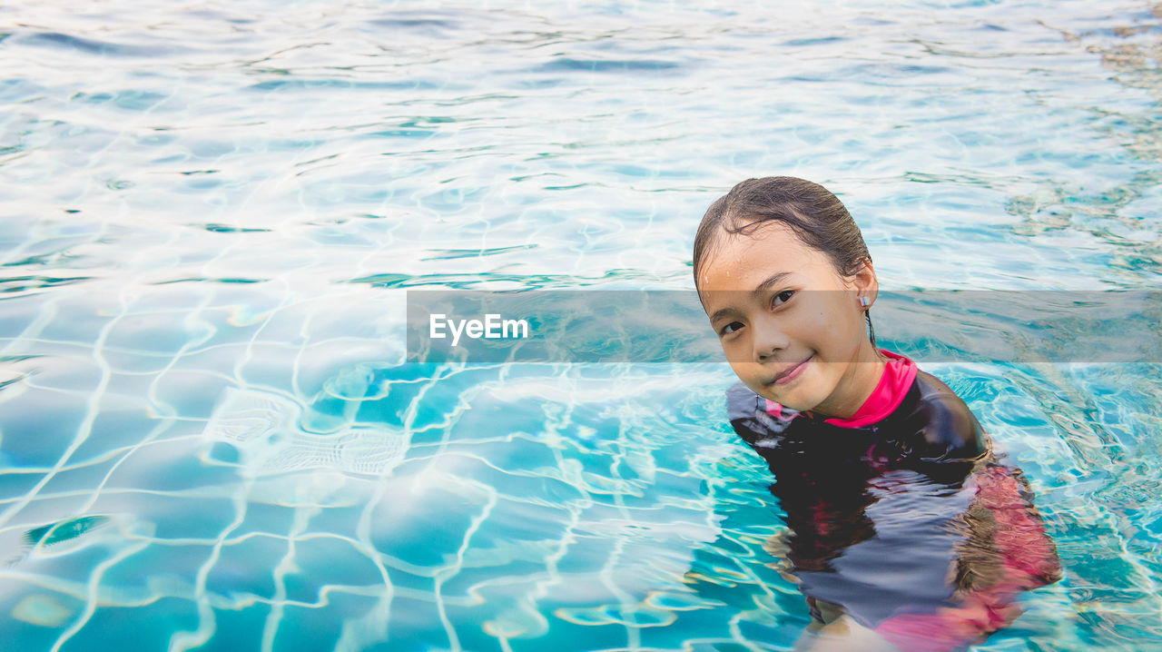 Portrait of smiling girl in swimming pool