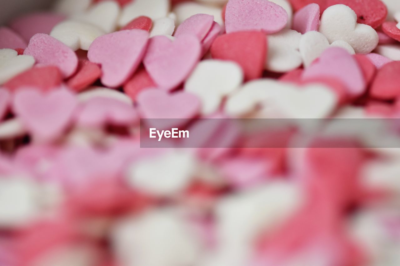 pink, petal, love, food, heart shape, dessert, large group of objects, heart, valentine's day, positive emotion, candy, sweet food, food and drink, abundance, sweet, selective focus, emotion, flower, no people, close-up, candy heart, indoors, icing, sweetness, freshness, celebration, confectionery