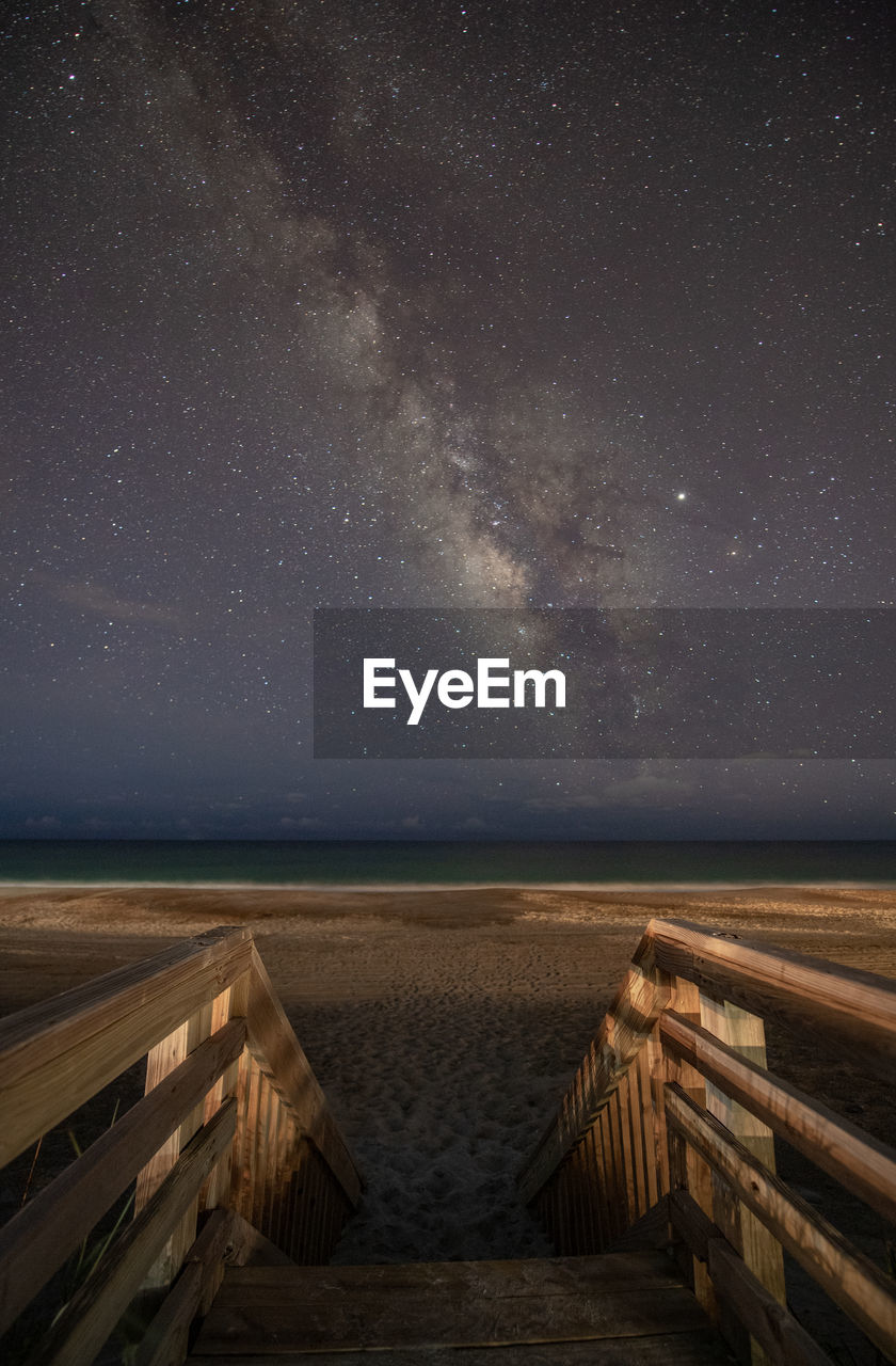 Steps at beach against star field