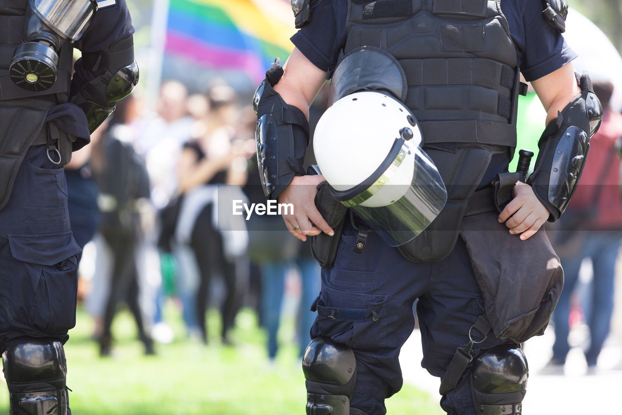 Midsection of police force during protest