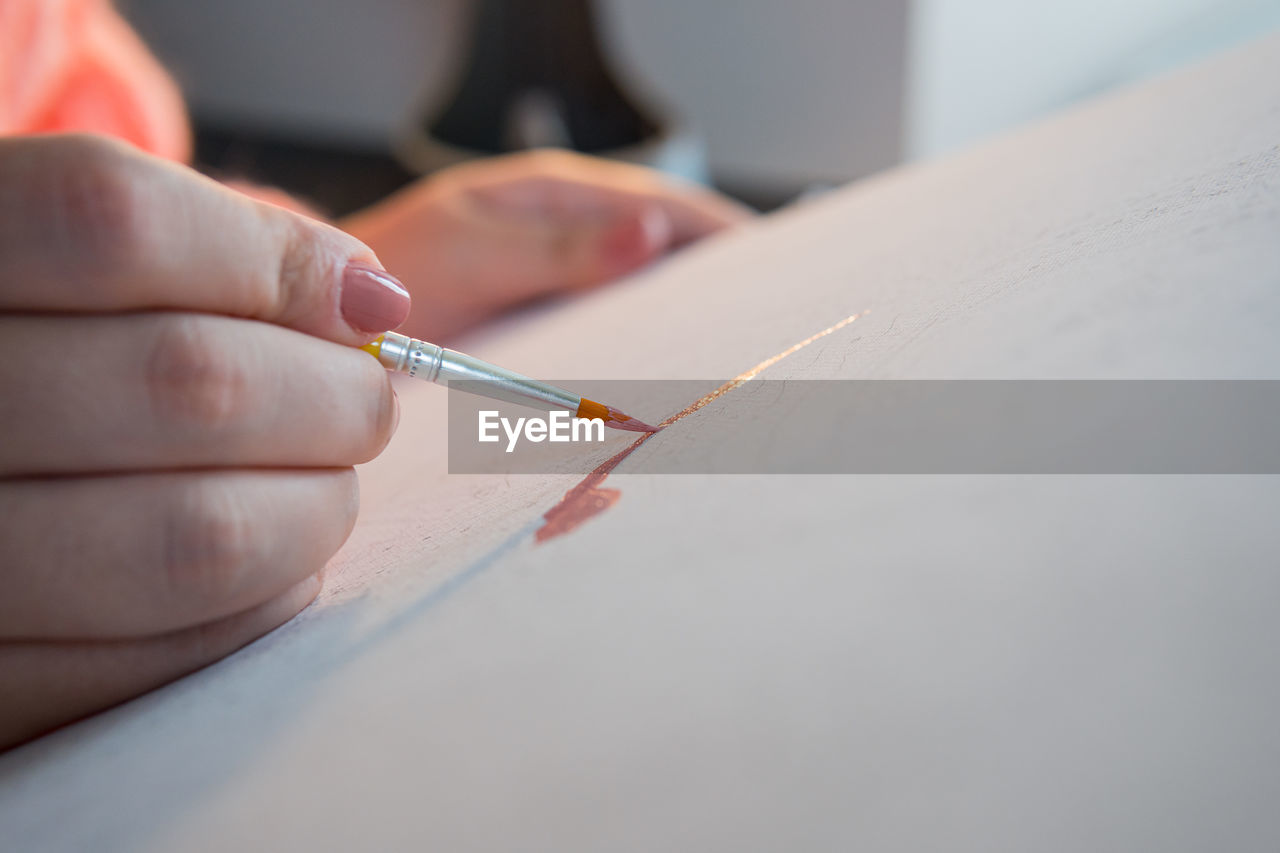 writing, hand, one person, indoors, adult, close-up, skill, selective focus, occupation, holding, creativity, women, accuracy, finger, craft, working, art