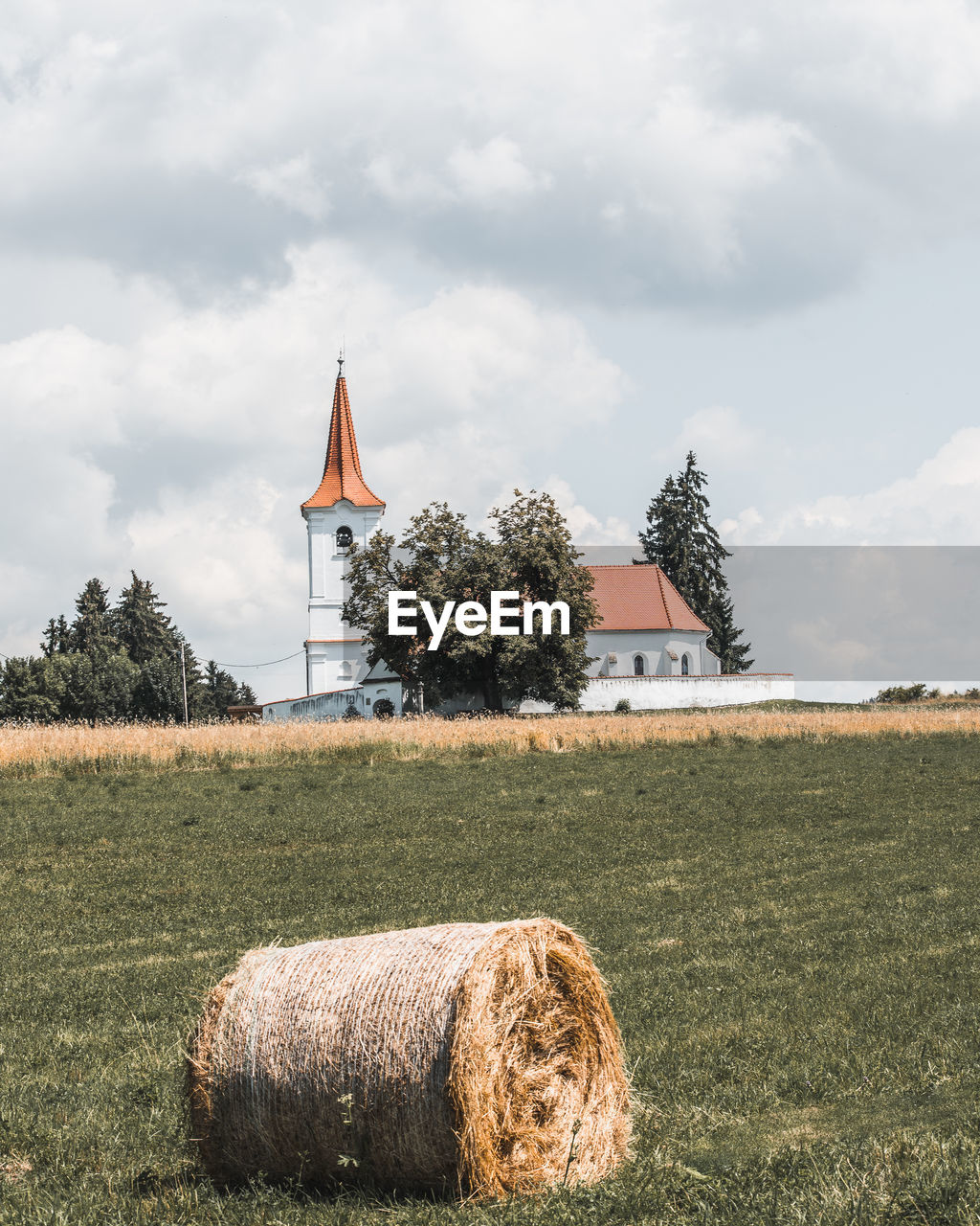 Village church with hay bale