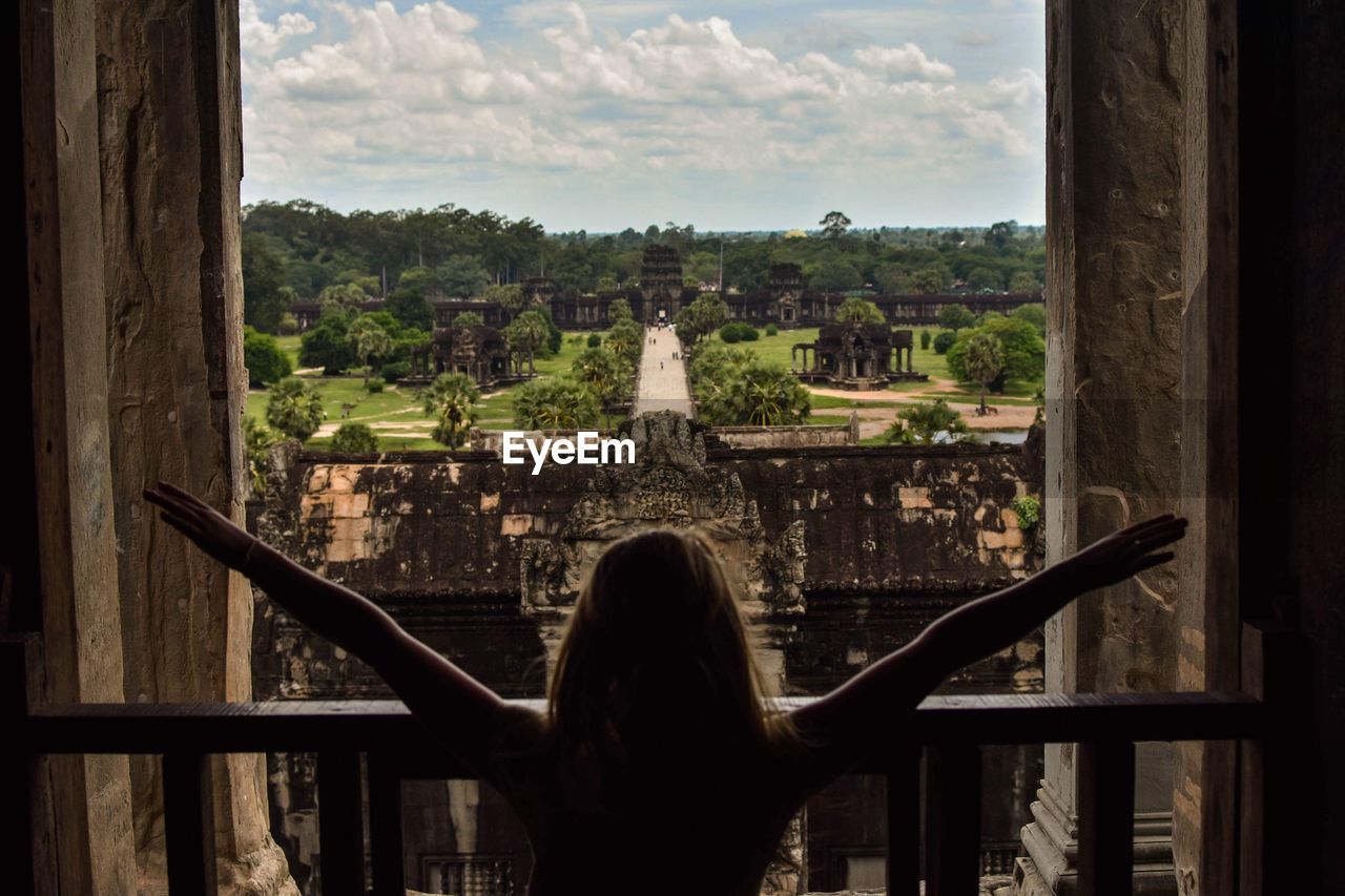 Rear view of woman looking at view against sky