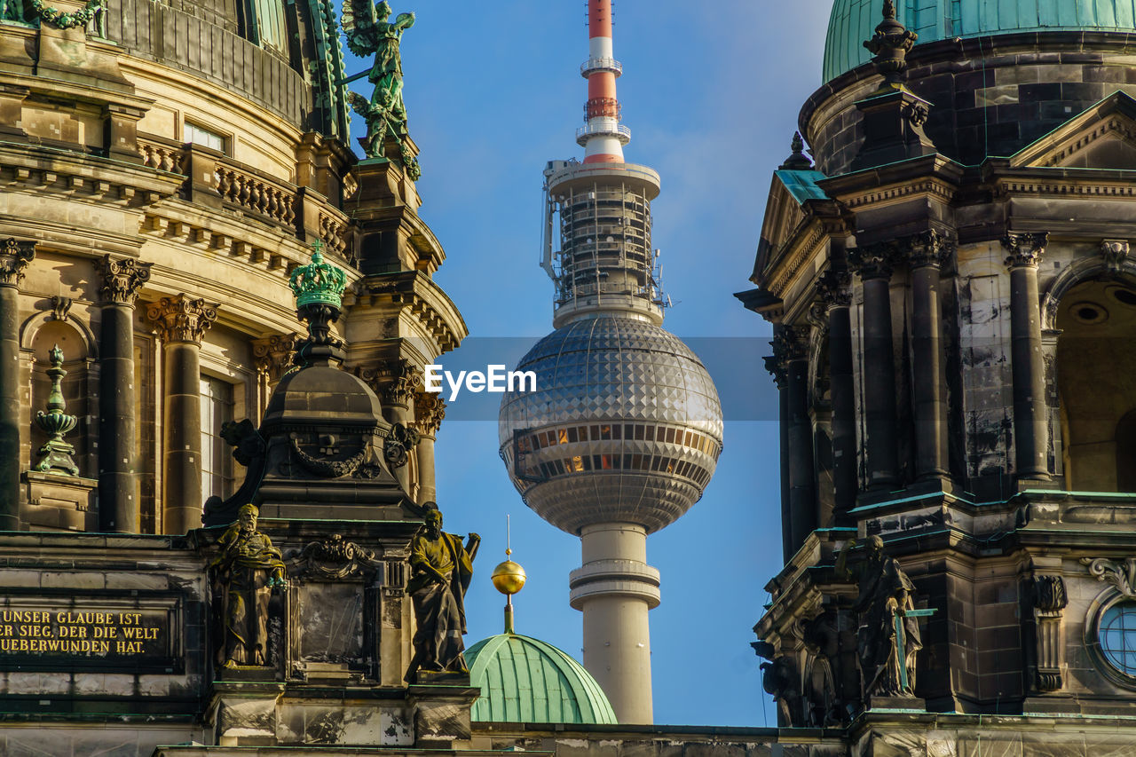 Low angle view of cathedral and fernsehturm against sky