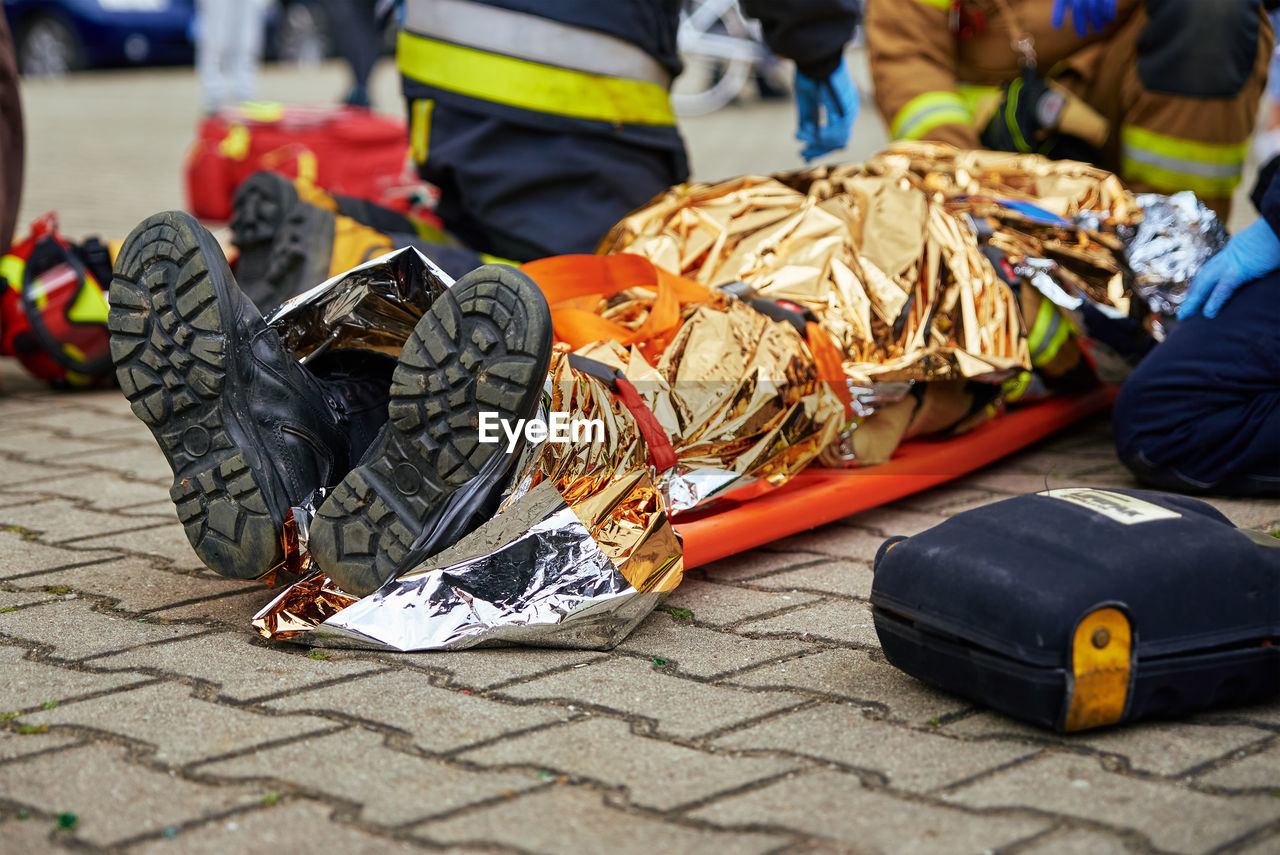 Rescuers provide first aid to the victim during car road accident