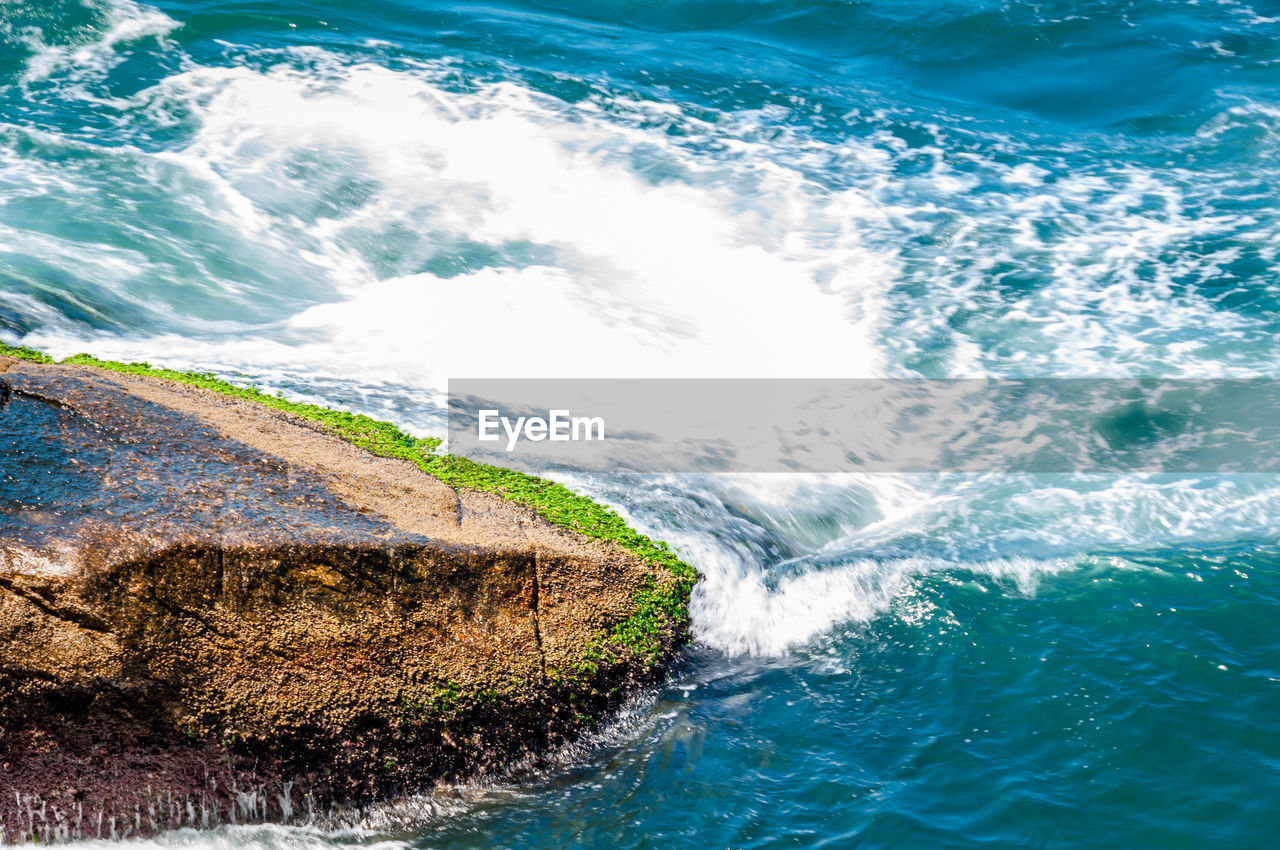 High angle view of sea by rock formation