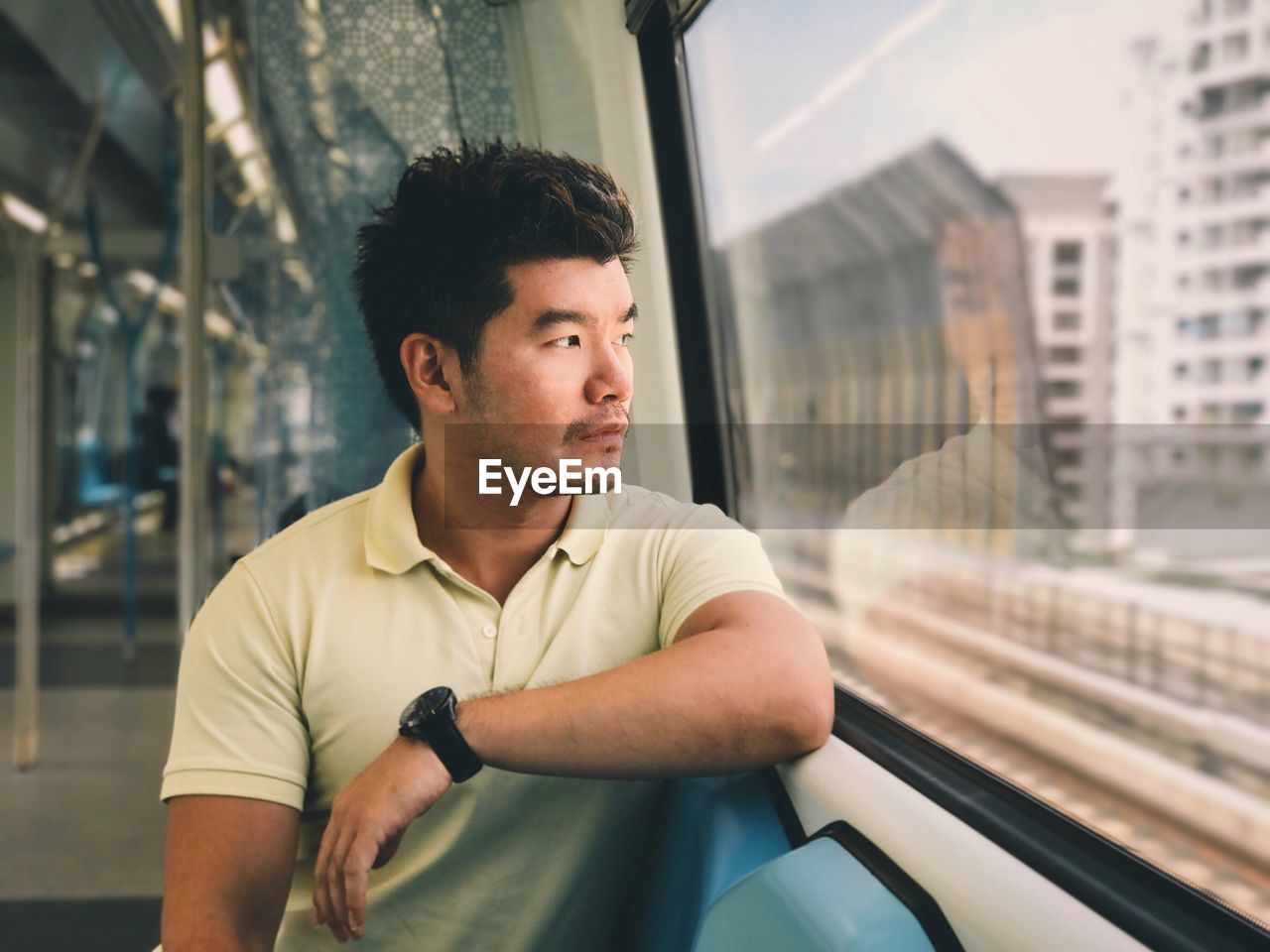 Man sitting on train window