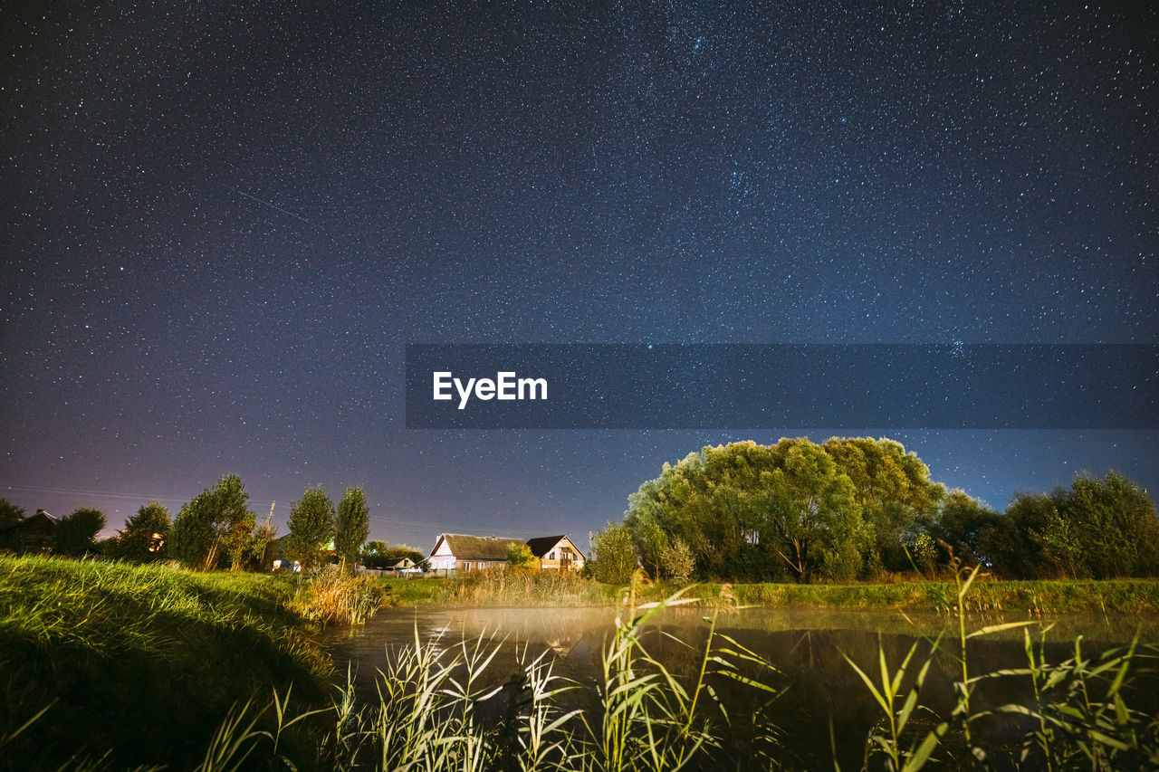 scenic view of grassy field against sky at night