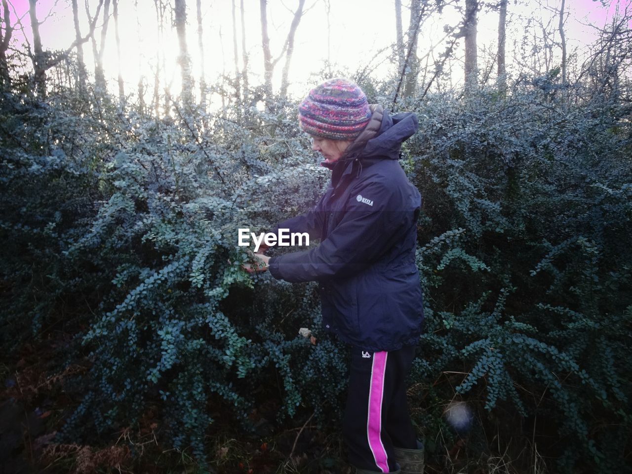 WOMAN STANDING IN FOREST