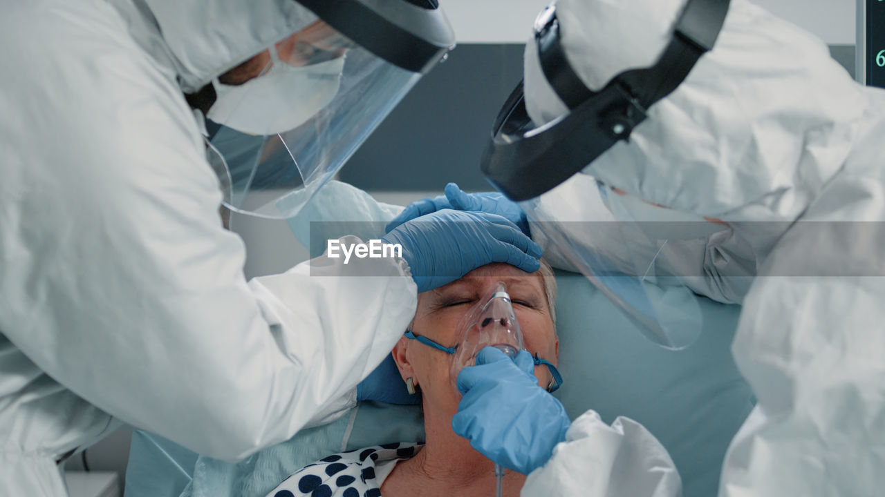 Midsection of doctor examining patient in hospital