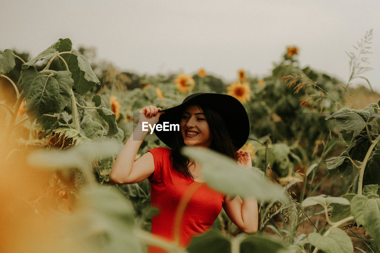 Young woman standing at sunflower farm